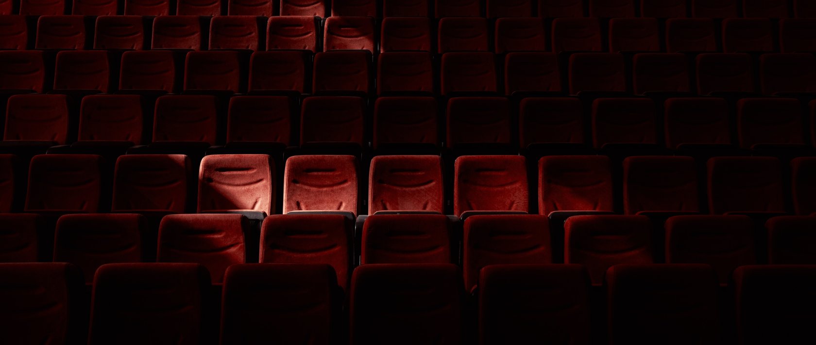 Red empty seats at a cinema. (Shutterstock Photo)