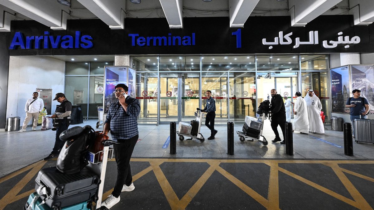 Passengers arrive at Kuwait International Airport in Kuwait City on June 1, 2026. (AFP Photo)