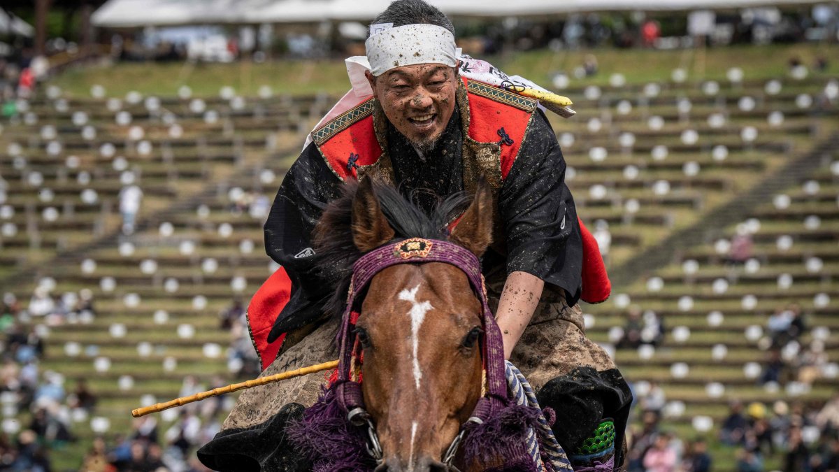 A horseman clad in samurai armor reacts after competing in the Yoinori Keiba race during the Soma Nomaoi festival at Hibarigahara field in Minamisoma, Fukushima prefecture, Japan, May 23, 2026. (AFP Photo)