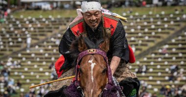 A horseman clad in samurai armor reacts after competing in the Yoinori Keiba race during the Soma Nomaoi festival at Hibarigahara field in Minamisoma, Fukushima prefecture, Japan, May 23, 2026. (AFP Photo)