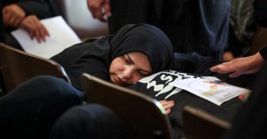 A woman mourns over a body, on the day of the funeral of Lebanese parents Hassan Abdullah and Hanan Shehab and their children Leen, Ali, Ibraheem and Julia, who were killed in an Israeli strike, in Wardaniyeh, Lebanon, June 3, 2026. (Reuters Photo)