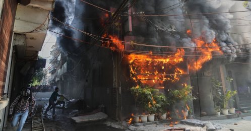Local people attempt to douse a fire at a hotel in New Delhi, India, June 3, 2026. (AP Photo)
