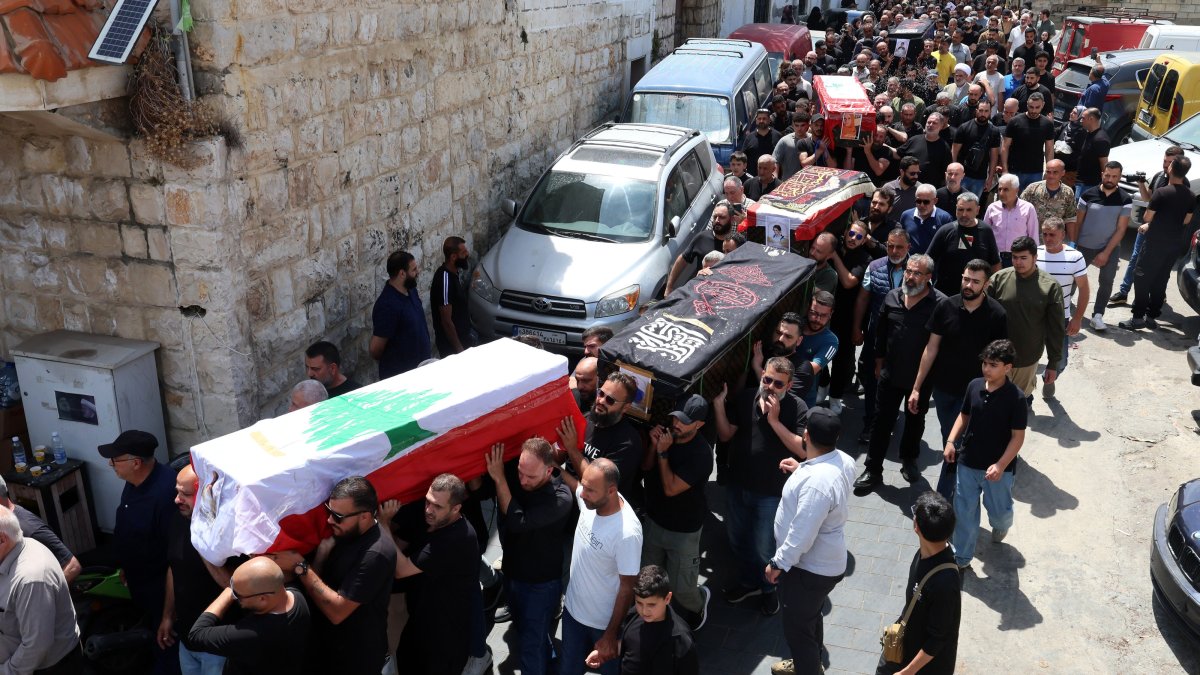 Mourners carry the coffins of members of a displaced Lebanese family, parents Hassan Abdullah and Hanan Shehab, along with their children Leen, Ali, Ibrahim and Julia, who were killed in an Israeli airstrike, during their funeral procession, Wardaniyeh, Lebanon, June 3, 2026. (EPA Photo)