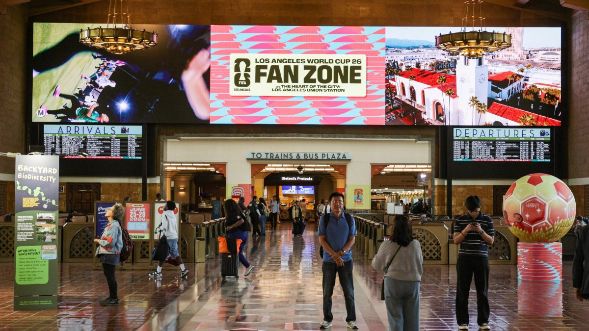 Transit riders take photos in front of the FIFA World Cup signage at Union Station, Los Angeles, U.S., June 3, 2026. (EPA Photo)