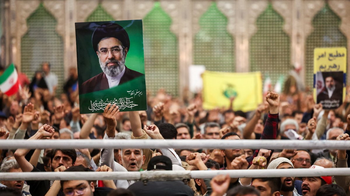 A man holds a placard with an image of Iran's Supreme Leader Mojtaba Khamenei during a ceremony on the 37th anniversary of the death of Ayatollah Ruhollah Khomeini, the leader of Iran's 1979 Islamic Revolution, at Khomeini's shrine in southern Tehran, Iran June 4, 2026. (Reuters Photo)