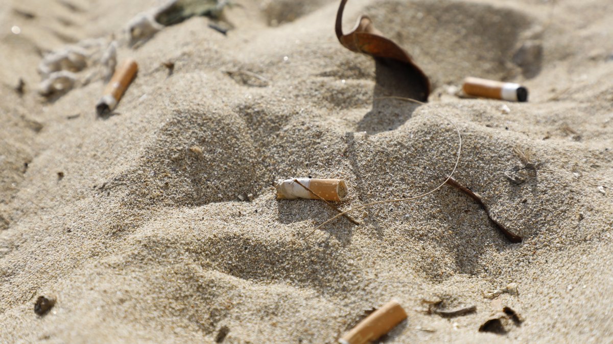 Cigarette butts lie in the sand on the beach, Palma, Spain, Jan. 15, 2022. (Getty Images Photo)