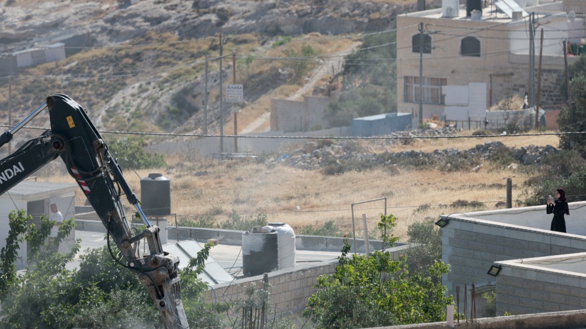 An Israeli military excavator demolishes a Palestinian building in the town of Jabaa in the Israeli-occupied West Bank, near Jerusalem June 3, 2026. (Reuters Photo)