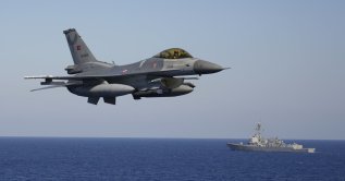 A Turkish F-16 fighter jet flies over naval ships during an annual NATO naval exercise on Türkiye's western coast on the Mediterranean, Sept. 15, 2022. (AP Photo)