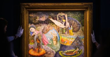 Art handlers hold "Les Distractions de Dagobert" by Leonora Carrington during a press preview at Sotheby's, New York City, U.S., May 3, 2024. (Getty Images Photo)