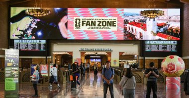Transit riders take photos in front of the FIFA World Cup signage at Union Station, Los Angeles, U.S., June 3, 2026. (EPA Photo)