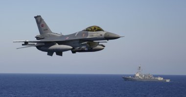 A Turkish F-16 fighter jet flies over naval ships during an annual NATO naval exercise on Türkiye's western coast on the Mediterranean, Sept. 15, 2022. (AP Photo)