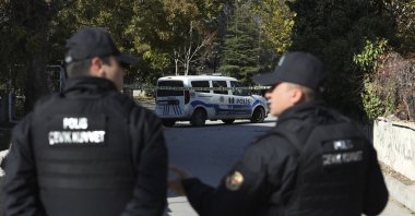 Police officers stand at the entrance of a neighborhood, Ankara, Türkiye, Nov. 11, 2022. (AP Photo)