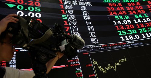 A cameraman films TSMC stock prices at the Taiwan Stock Exchange in Taipei, Taiwan, April 21, 2026. (Reuters Photo)