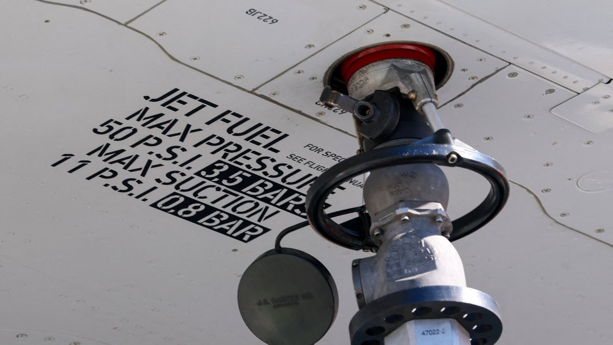A nozzle attached under the wing of an aircraft during refuelling with jet fuel, Cointrin Airport, Geneva, Switzerland, April 24, 2026. (Reuters Photo)