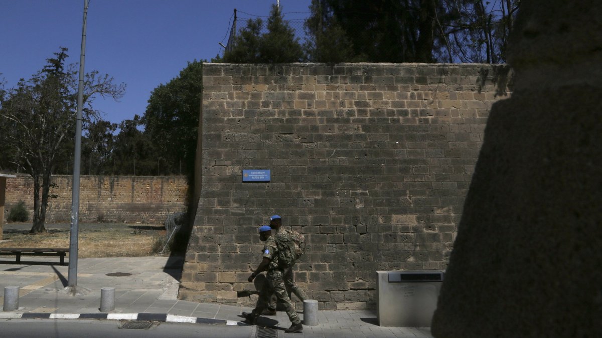 U.N peacekeepers walk by the Venice wall at the medieval core across the U.N buffer zone, in the divided capital Lefkoşa (Nicosia), Cyprus, April 26, 2021. (AP File Photo)