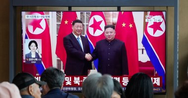 People watch a TV screen showing a file image of North Korean leader Kim Jong Un (R) and Chinese President Xi Jinping, at the Seoul Railway Station, Seoul, South Korea, June 5, 2026. (AP Photo)