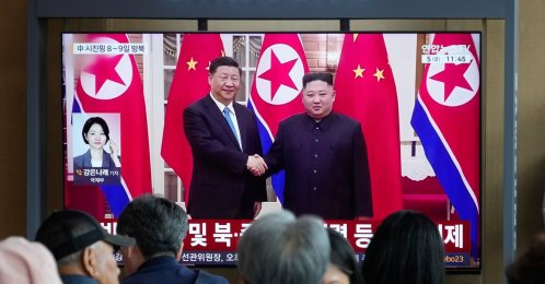 People watch a TV screen showing a file image of North Korean leader Kim Jong Un (R) and Chinese President Xi Jinping, at the Seoul Railway Station, Seoul, South Korea, June 5, 2026. (AP Photo)