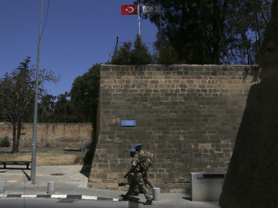 U.N peacekeepers walk by the Venice wall at the medieval core across the U.N buffer zone, in the divided capital Lefkoşa (Nicosia), Cyprus, April 26, 2021. (AP File Photo)