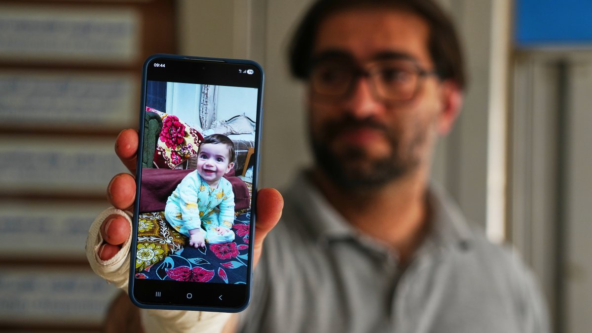 Fahd Abu Haikal, 41, displays a mobile photo of his seven-month-old boy Sam, who was killed Friday when Israeli soldiers fired at the vehicle carrying him and his parents, in Tel Rumeida, Hebron, occupied West Bank, June 6, 2026. (AP Photo)