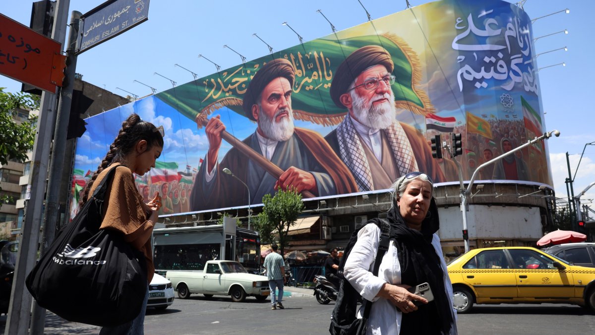 Iranians walk past a huge billboard featuring late Iranian Supreme Leader Ayatollah Ruhollah Khomeini and Supreme Leader Ayatollah Ali Khamenei, in Tehran, Iran, June 7, 2026. (EPA Photo)