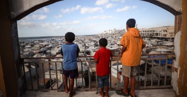 Three Palestinian children look down at tents housing displaced Palestinians in Gaza, Palestine, Sept. 3, 2025. (Getty Images Photo)