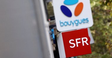 The logos of French telecom operators Bouygues and SFR are seen on shops in Paris, France, Oct. 15, 2025. (Reuters Photo)