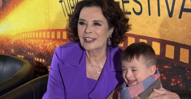 Turkish actress Hülya Koçyiğit, the guest of honor at the first-ever Turkish Film Festival in Düsseldorf, poses with a child, Düsseldorf, Germany, June 6, 2026. (AA Photo)