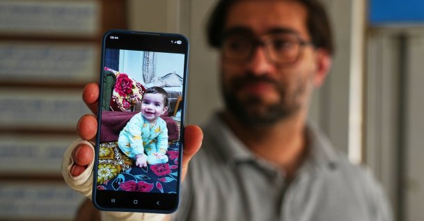 Fahd Abu Haikal, 41, displays a mobile photo of his seven-month-old boy Sam, who was killed Friday when Israeli soldiers fired at the vehicle carrying him and his parents, in Tel Rumeida, Hebron, occupied West Bank, June 6, 2026. (AP Photo)