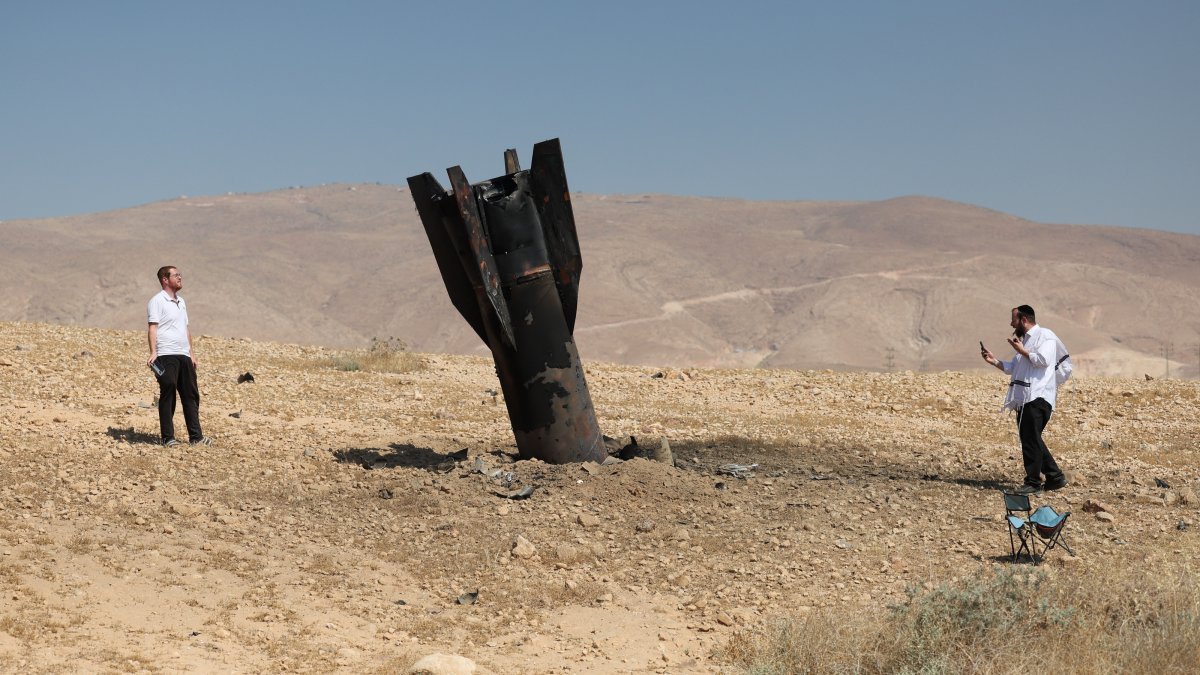 People look at the remains of an Iranian ballistic missile that landed in an open field next to the illegal Jewish settlement of Mevo'ot Yericho at the Jordan Valley, Israel-occupied West Bank, June 8, 2026. (EPA Photo)