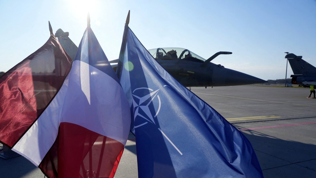 Latvian, French and NATO flags flutter in front of a French Rafale fighter jet of the NATO Baltic Air Policing mission, in the Lielvarde air base, Latvia, April 14, 2026. (Reuters Photo)