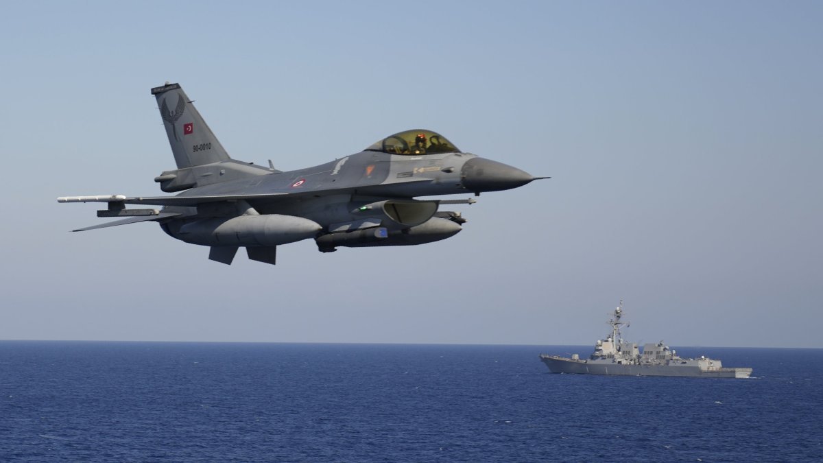 A Turkish F-16 fighter jet flies over naval ships during an annual NATO naval exercise on Türkiye's western coast on the Mediterranean, Sept. 15, 2022. (AP Photo)