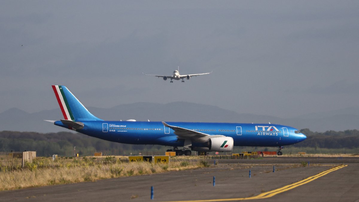 An ITA Airways aircraft stands on the tarmac as another aircraft approaches Rome's Fiumicino airport, in Fiumicino, Italy, June 6, 2026. (Reuters Photo)