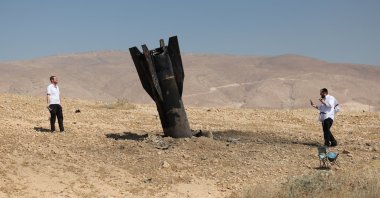 People look at the remains of an Iranian ballistic missile that landed in an open field next to the illegal Jewish settlement of Mevo'ot Yericho at the Jordan Valley, Israel-occupied West Bank, June 8, 2026. (EPA Photo)