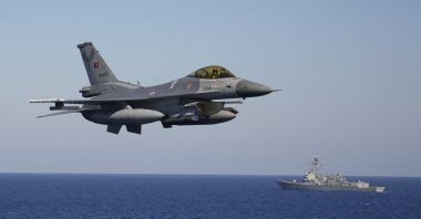 A Turkish F-16 fighter jet flies over naval ships during an annual NATO naval exercise on Türkiye's western coast on the Mediterranean, Sept. 15, 2022. (AP Photo)