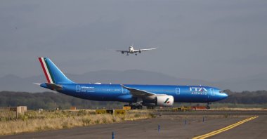 An ITA Airways aircraft stands on the tarmac as another aircraft approaches Rome's Fiumicino airport, in Fiumicino, Italy, June 6, 2026. (Reuters Photo)