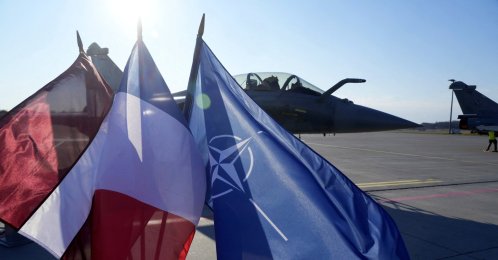Latvian, French and NATO flags flutter in front of a French Rafale fighter jet of the NATO Baltic Air Policing mission, in the Lielvarde air base, Latvia, April 14, 2026. (Reuters Photo)