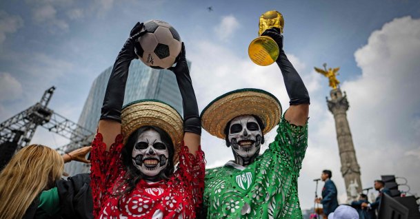 A fan holds a replica of the World Cup trophy while taking part in a Guinness World Record attempt for the world’s largest Mexican Wave, Mexico City, Mexico, June 6, 2026. (AFP Photo)