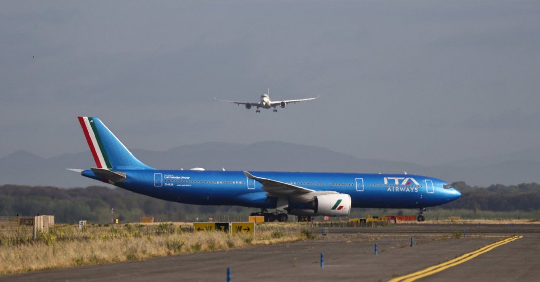 An ITA Airways aircraft stands on the tarmac as another aircraft approaches Rome's Fiumicino airport, in Fiumicino, Italy, June 6, 2026. (Reuters Photo)