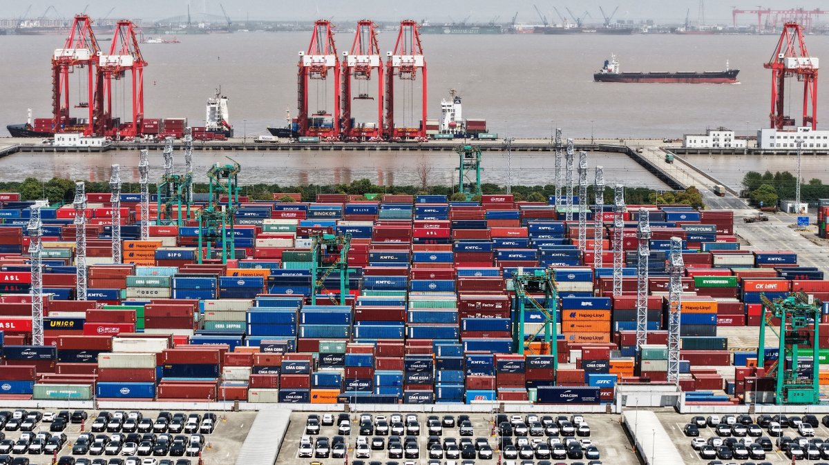 A drone view shows electric vehicles for export and containers sitting at a port, Shanghai, China, April 13, 2025. (Reuters Photo)