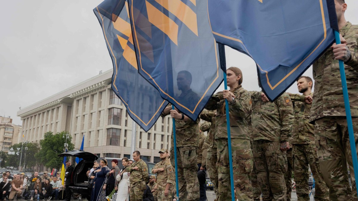 Mourners stand during the funeral ceremony of Yaroslav Varnak, a 23-year-old serviceman who was killed in action, Kyiv, Ukraine, June 8, 2026. (AFP)