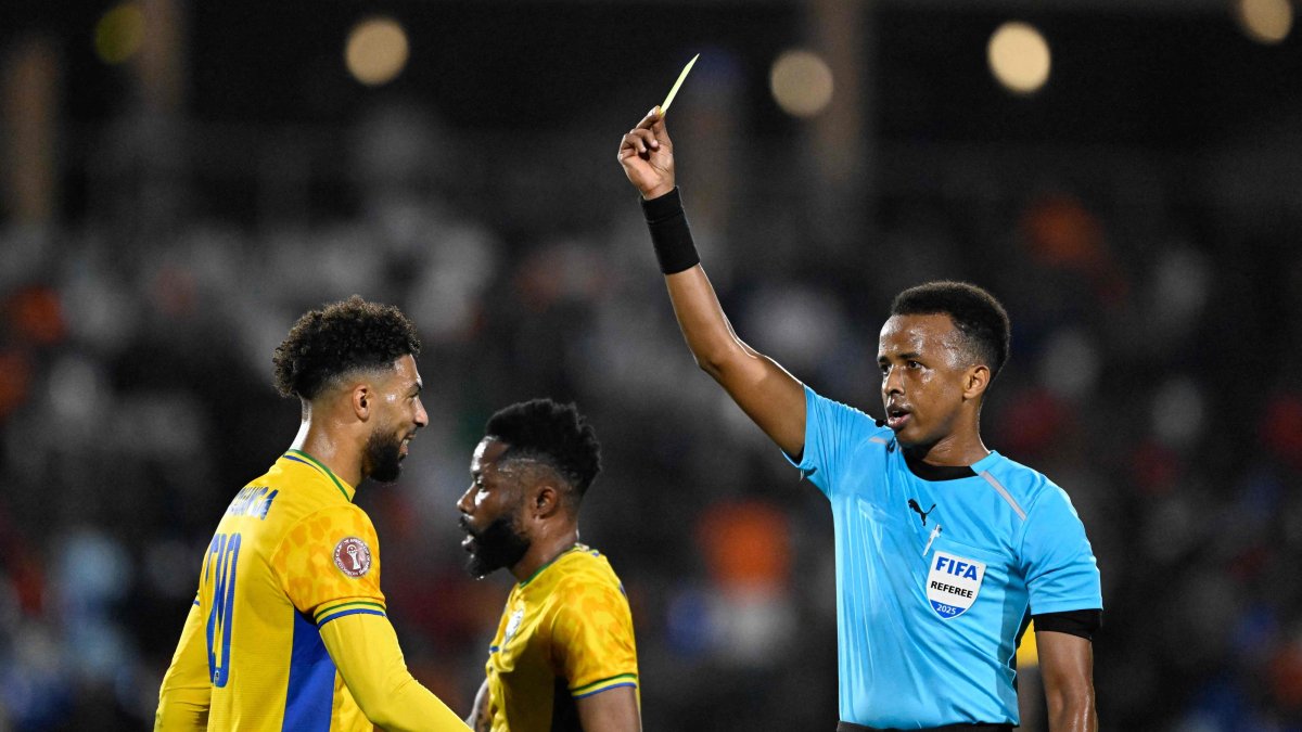 Gabon's forward #20 Denis Bouanga is shown the yellow card by Somali referee Omar Abdulkadir Artan during the Africa Cup of Nations (CAN) Group F football match between Gabon and Ivory Coast at the Grand Stadium in Marrakech, Dec. 31, 2025. (AFP Photo)