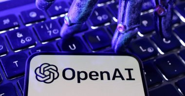 OpenAI logo, a keyboard, and a robotic hand in this illustration taken June 5, 2026. (Reuters Photo)