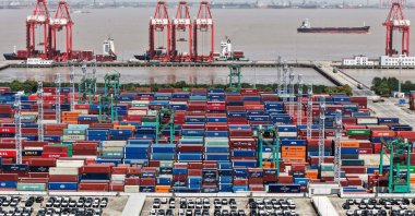 A drone view shows electric vehicles for export and containers sitting at a port, Shanghai, China, April 13, 2025. (Reuters Photo)