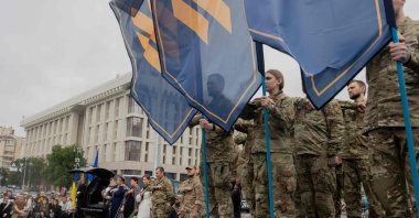 Mourners stand during the funeral ceremony of Yaroslav Varnak, a 23-year-old serviceman who was killed in action, Kyiv, Ukraine, June 8, 2026. (AFP)