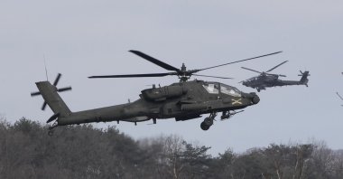 U.S. Army AH-64 Apache helicopters fly during a combined live fire drill with South Korea in Pocheon, South Korea, Feb. 10, 2025. (AP Photo)