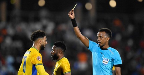 Gabon's forward #20 Denis Bouanga is shown the yellow card by Somali referee Omar Abdulkadir Artan during the Africa Cup of Nations (CAN) Group F football match between Gabon and Ivory Coast at the Grand Stadium in Marrakech, Dec. 31, 2025. (AFP Photo)
