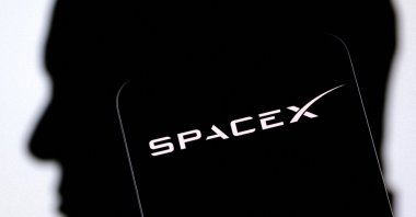 The SpaceX logo and Elon Musk's silhouette are seen in this illustration created on Dec. 19, 2022. (Reuters Photo)