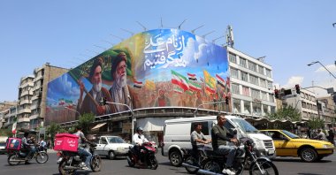 Iranians drive past a large billboard featuring late Iranian Supreme Leader Ayatollah Ruhollah Khomeini and Supreme Leader Ayatollah Ali Khamenei on a street in Tehran, Iran, June 10, 2026. (EPA Photo)