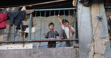 Children watch Palestinians playing football inside a school sheltering displaced people at the Jabalia refugee camp in the northern Gaza Strip, Palestine, June 9, 2026. (AFP Photo)