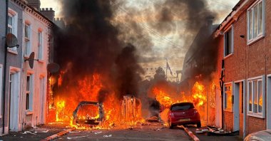 Vehicles set on fire by anti-immigrant rioters burn on Lendrick Street in east Belfast, Northern Ireland, June 9, 2026. (AP Photo)